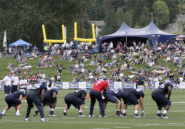 Fans watch the Seahawks practice at training camp at the VMAC in Renton.