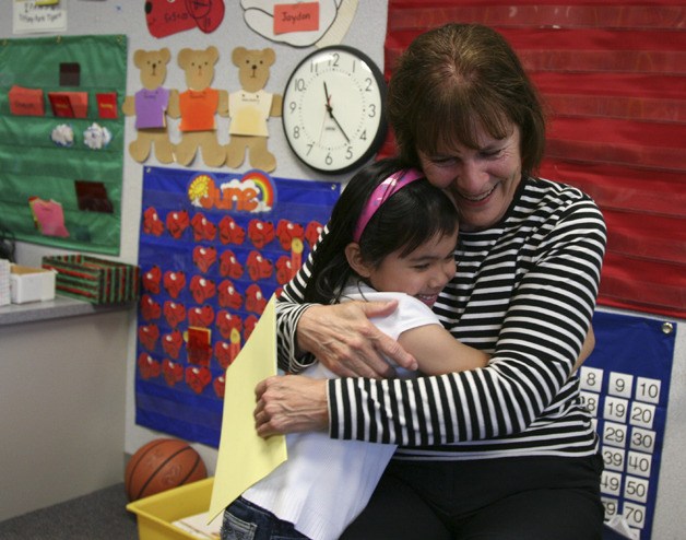 Teacher Sue Brumfield hugs kindergartner Leonie Nguyen the last day of school. Brumfield is retiring after working in the Renton school district for 40 years.