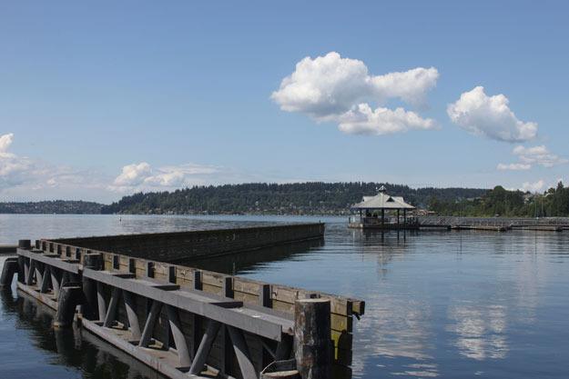 Fluffy white clouds hang in a blue sky over Lake Washington at Gene Coulon Park. Should be plenty of blue skies this weekend.