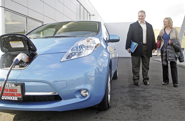 Patrick VanDerHyde and his wife Debbie of Seattle walk out of the Renton Younker Nissan to take a look at their new electric Leaf.