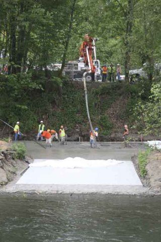 Workers finished paving the road Tuesday to the Cedar River that will provide access to a fish weir Seattle Public Utilities and the state Department of Fish and Wildlife will install again this fall in the river.