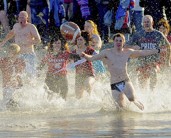 Plungers race into Lake Washington in this file photo from the 2015 Polar Bear Plunge.