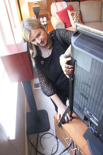 Kelly Kaspar of the American Red Cros demonstrates how to secure a flat screen TV.