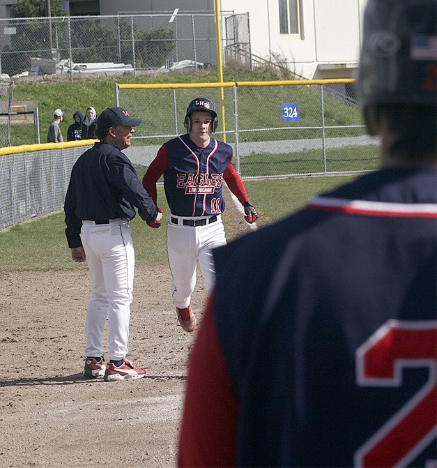 Lindbergh's Cameron Callen rounds third base after a second-inning home run April 11 while his teammates wait for him to celebrate at home plate.