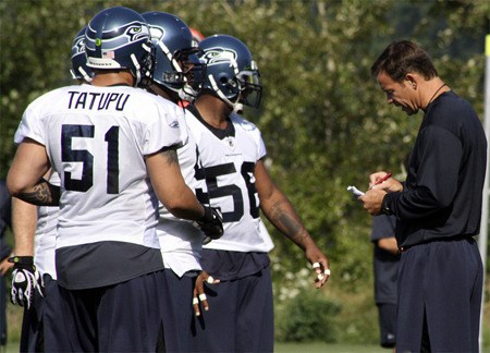 Former Seahawks coach Jim Mora working with players at a training camp practice Aug. 3.