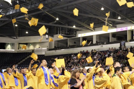 Hazen High School's graduating seniors toss their caps into the air at the conclusion of commencement Tuesday at ShoWare Center in Kent.