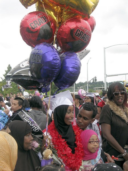 Renton High senior Ardo Jama is surrounded by supporters after the school's commencement Tuesday night at ShoWare Center in Kent.