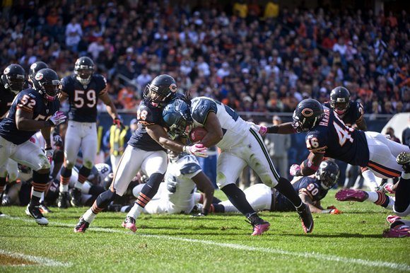 Seattle running back Marshawn Lynch pushes through a Chicago defender Oct. 17.