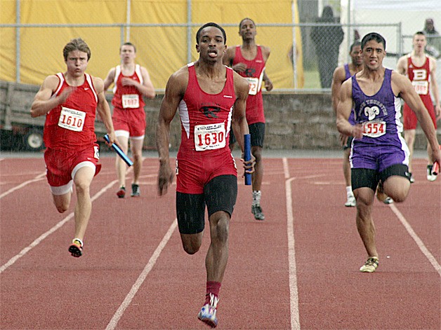 Renton's Justin Bennett sprints through a rain shower in the final leg of the 4 X 100 relay. The Indians won a 2A state title in the event and overall as a team. It was one of three titles for Bennett.