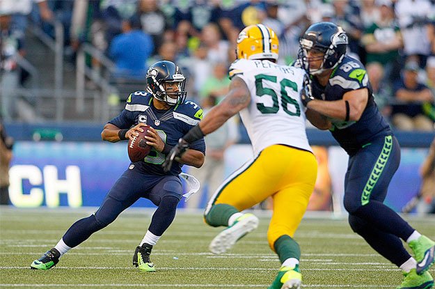 Russell Wilson avoids the defense during Sunday’s 36-16 victory over the Green Bay Packers.