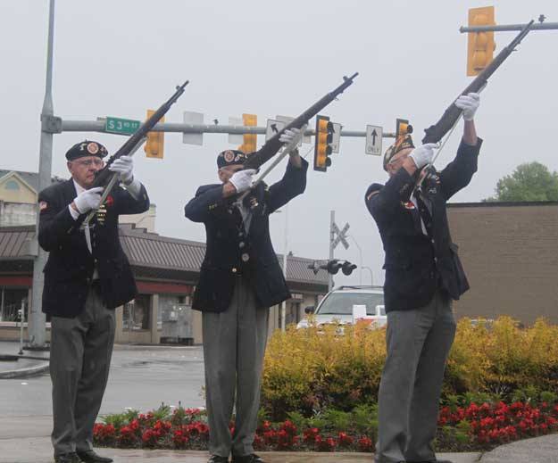 Members of the honor guard fire during the 21-gun salute during Monday's memorial Day Celebration at the Veterans Memorial in downtown Renton.