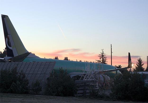 The sunset paints the sky a beautiful color over a 737 at Renton Municipal Airport in this shot from Renton Memorial Stadium