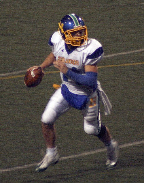 Hazen quarterback Travis Johnson rolls to his right in the Highlanders' playoff game Nov. 6 against Franklin.