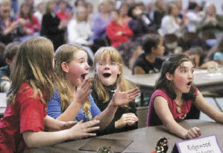 A team of sixth-grade students from Ridgewood Elementary School reacts upon winning the third-annual Battle of the Books Friday at Glenridge Elementary School. The team of Isabelle Ayers (left to right)