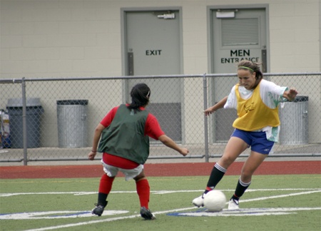 Liberty sophomore Denise Blohowiak dribbles around fellow sophomore Shannon Daly during a drill at a Patriots’ practice.