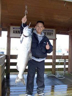 Viet Vo displays a 21-pound  Chinook salmon he caught off Westport.