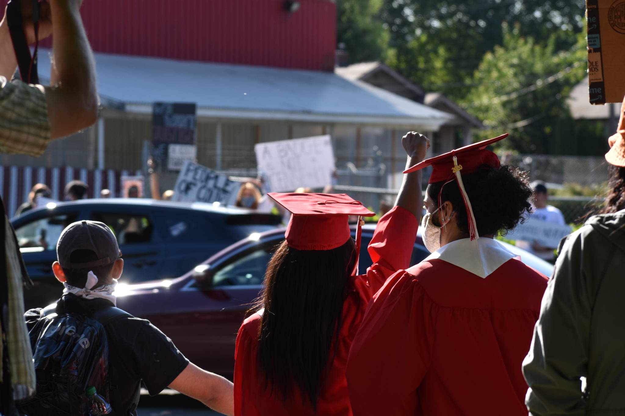 Renton High School seniors came to the Renton protest still in their cap and gown from the drive-thru graduation ceremony, Monday, June 1. Photo by Haley Ausbun.