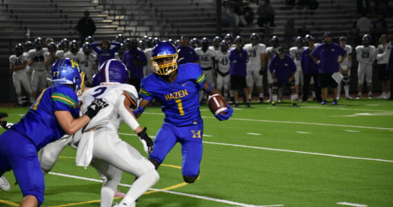 Senior Devaughn Daniels tries to avoid aa Kang tackler. Ben Ray / The Reporter