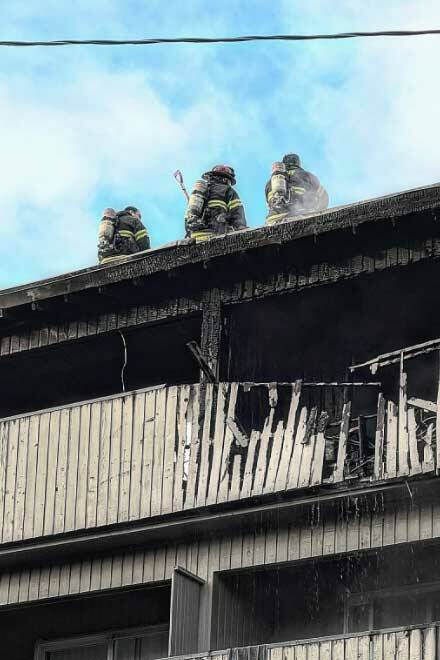 Responding firefighters on top of the apartment building. (Screenshot from King County Fire District 20 Facebook post)