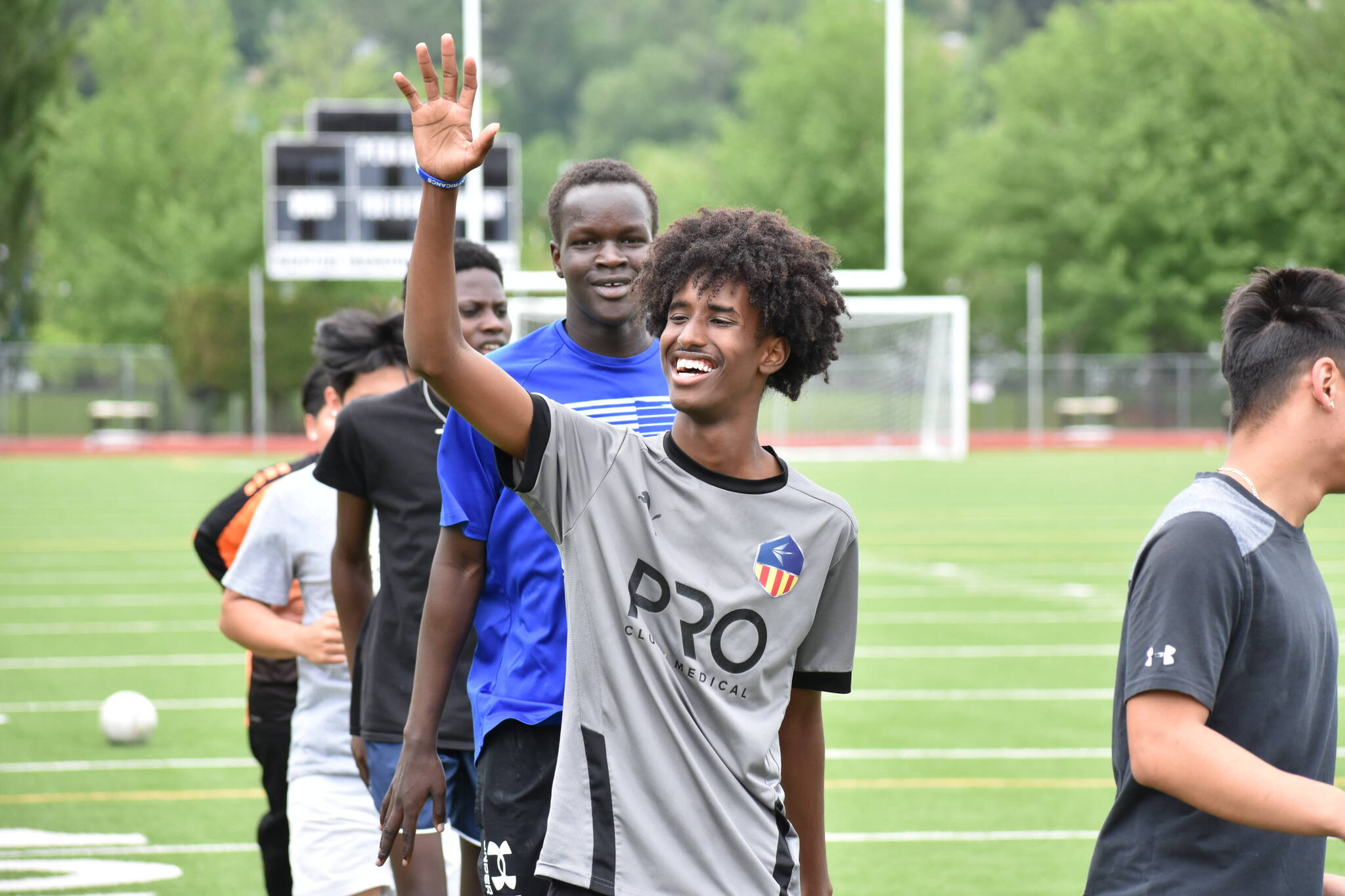 Mohamed Abdi gives a wave during training at Renton Memorial Stadium. Ben Ray / The Reporter