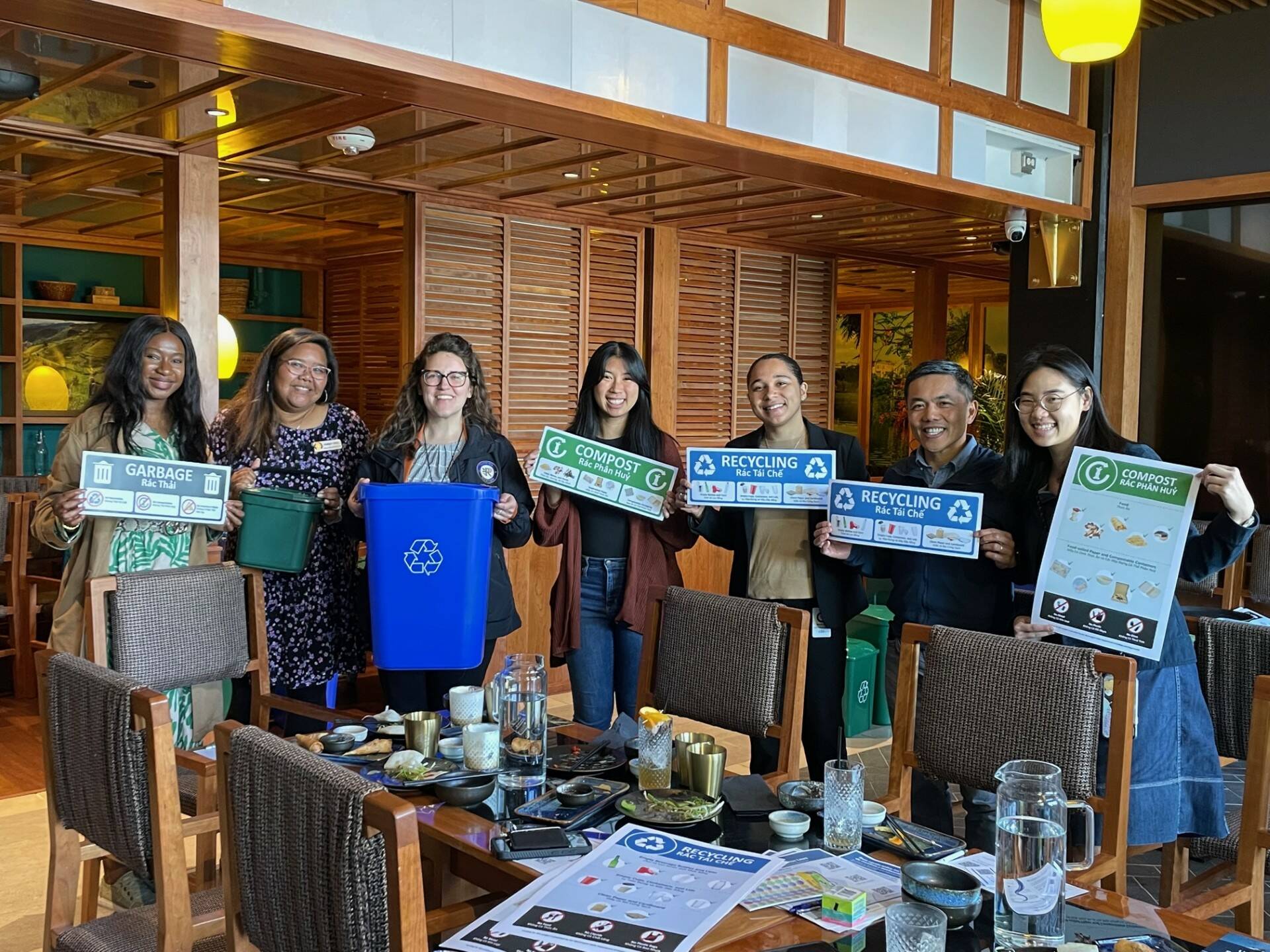 The outreach event at Anchovies and Salt. Meara Huebach and others are holding up some of the free supplies that program participants can receive. Photo courtesy of Meara Huebach