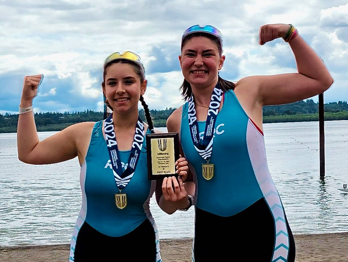 Lily Pahl (left) and Tabitha Pahl posing with their medals and plaque after their rowing win. Photo courtesy of Lesley Pahl