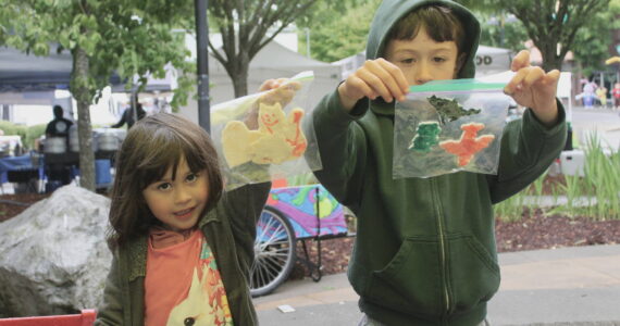 Nova and Matteo show off their crafts that they had made at the Kid’s Patch tent at the Renton Farmers Market. Photos by Bailey Jo Josie/Sound Publishing