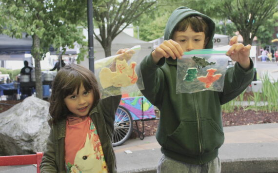 Nova and Matteo show off their crafts that they had made at the Kid’s Patch tent at the Renton Farmers Market. Photos by Bailey Jo Josie/Sound Publishing