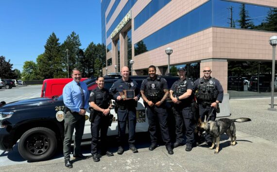 Deputy Chief R. Rutledge with Officer R. Hynes, Sgt. J. Trader (holding accreditation award), Officer E. Edmunds, Officer K. Petty, and K9 Officer D. Adam with K9 Xander. Photo Courtesy of Renton Police Department