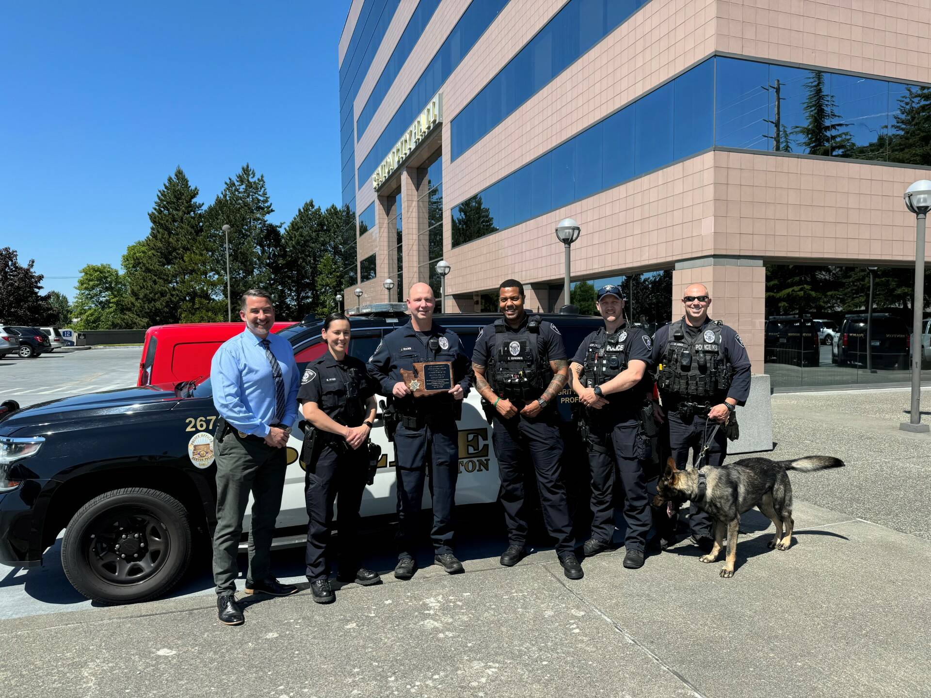 Deputy Chief R. Rutledge with Officer R. Hynes, Sgt. J. Trader (holding accreditation award), Officer E. Edmunds, Officer K. Petty, and K9 Officer D. Adam with K9 Xander. Photo Courtesy of Renton Police Department