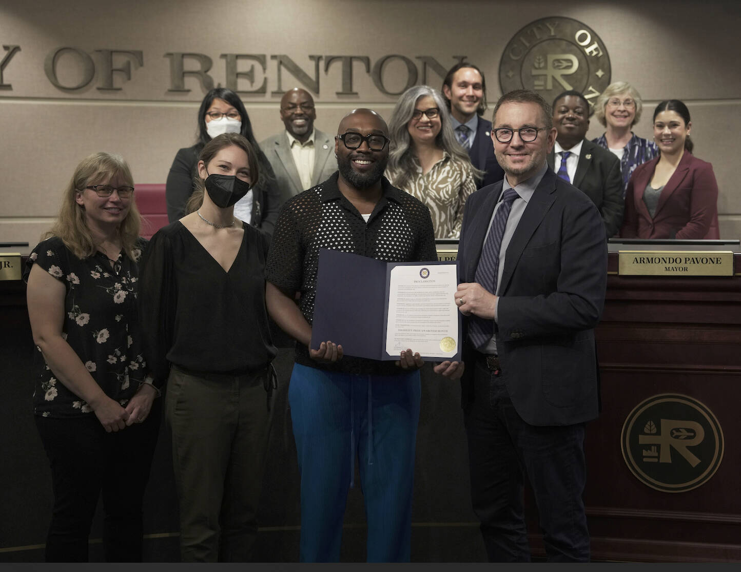 Kristina Brown, Director of Public Affairs at Kindering, and parent of Kindering client Rome Johnson posing with the declaration at the Renton City Council meeting. Courtesy photo