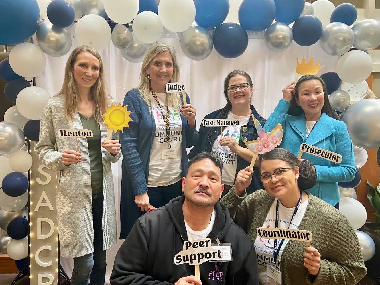 Joaquin “Ken” Delgado is pictured holding a “Peer Support” sign with other Renton Municipal Court employees. Photo courtesy of Joaquin Delgado