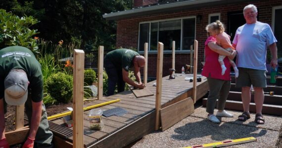 Corin Goodwin and Robert Goodwin with their granddaughter as her new ramp gets built. Photo by Joshua Solorzano/Renton Reporter