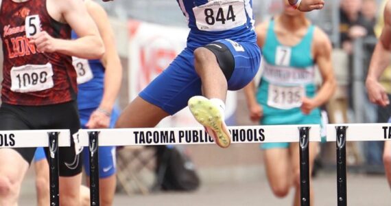 Kenyon Andrews in mid-air on his way to a state title. Photo provided by Keith Baker/ Instagram: KeithBakerLXVI