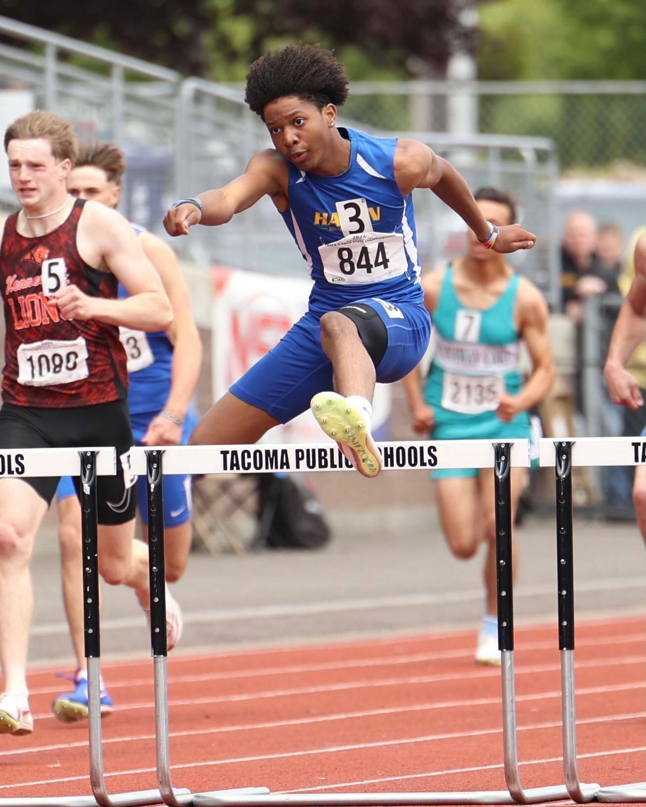 Kenyon Andrews in mid-air on his way to a state title. Photo provided by Keith Baker/ Instagram: KeithBakerLXVI