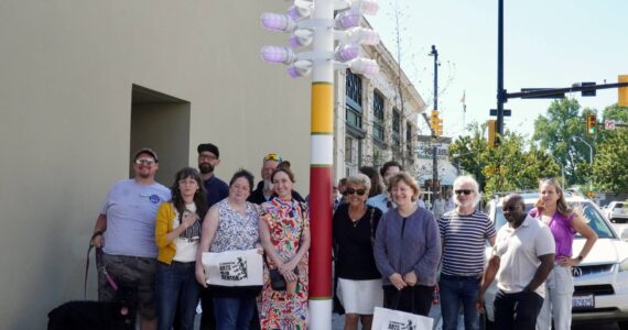 Renton Arts Commission members, various Renton employees, and a few council members gathered around the renewed streetlight. Photo by Joshua Solorzano/The Reporter