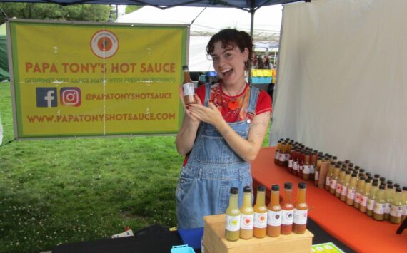 Raine Padawer, employee of Papa Tony’s, with her favorite flavor of hot sauce, the Ghostly Garlic. Photo courtesy of Annika Hauer