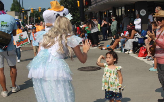 The tooth fairy gives a high five at the 2024 Renton River Days Parade. Photo by Bailey Jo Josie/Sound Publishing.