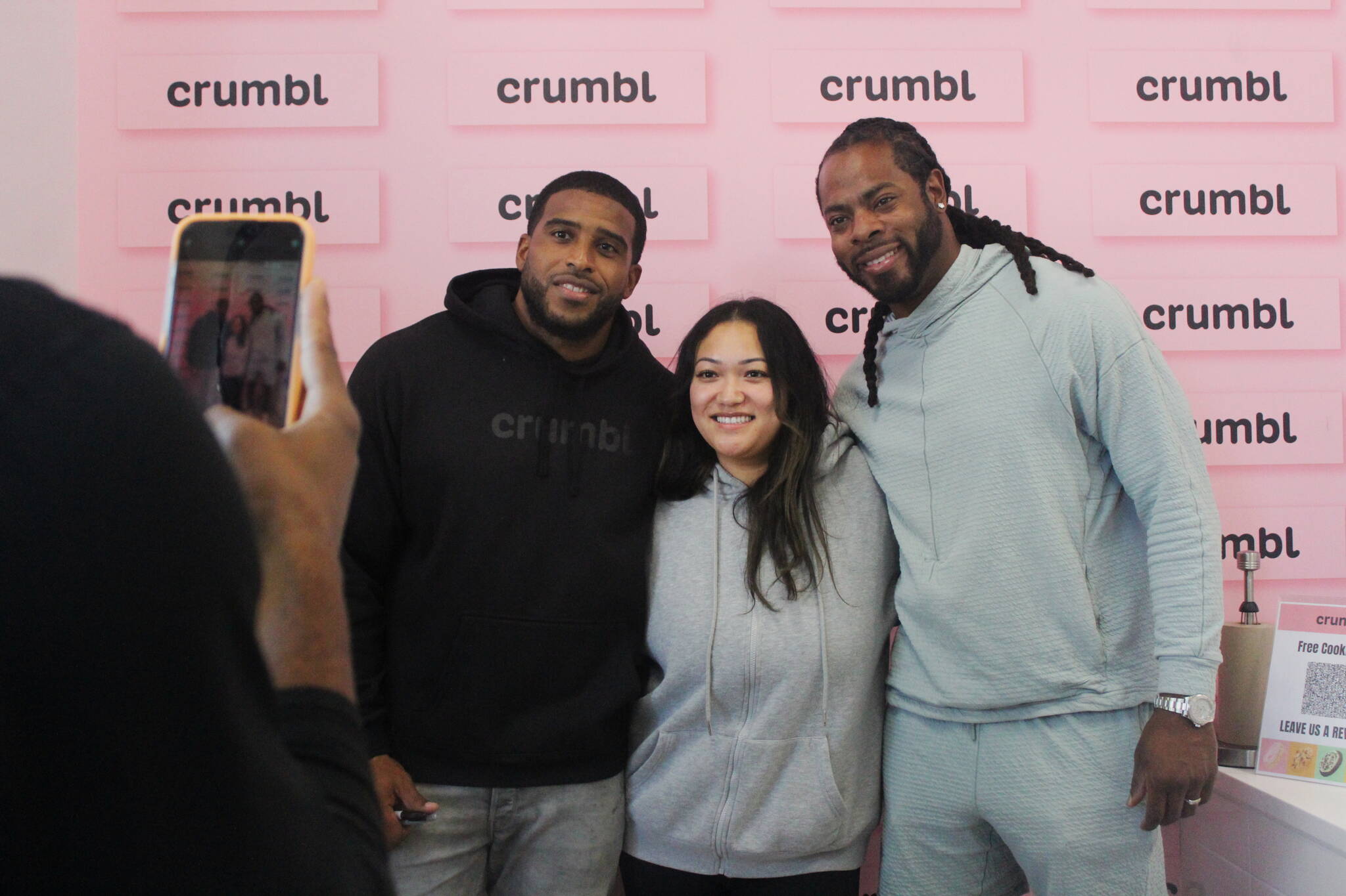 Wagner and Sherman sign autographs at the opening of Crumbl Cookies