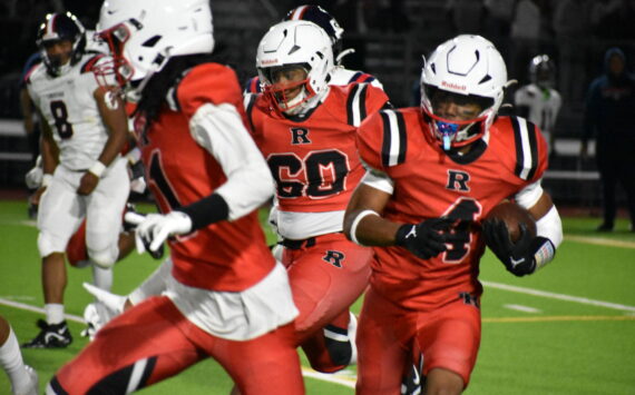 Renton junior Major Bloodsaw runs the ball with blockers in front. Ben Ray / The Reporter