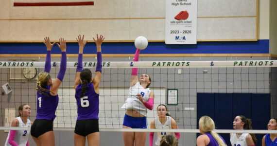 Liberty senior with a kill for the Patriots against Lake Washington. Ben Ray / The Reporter