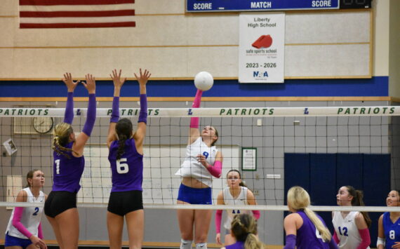 Liberty senior with a kill for the Patriots against Lake Washington. Ben Ray / The Reporter