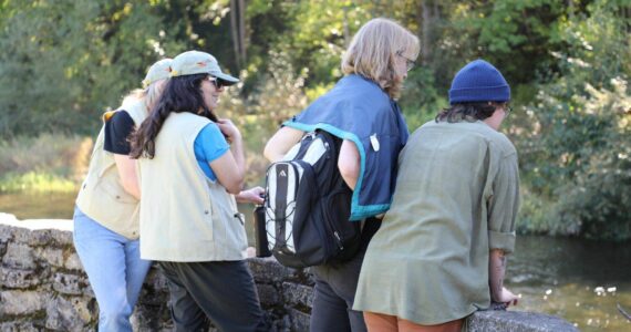 Volunteers educate community members about the returning Cedar River salmon. (Sound Publishing)