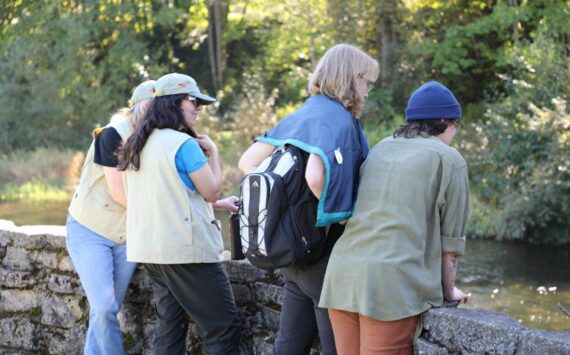 Volunteers educate community members about the returning Cedar River salmon. (Sound Publishing)