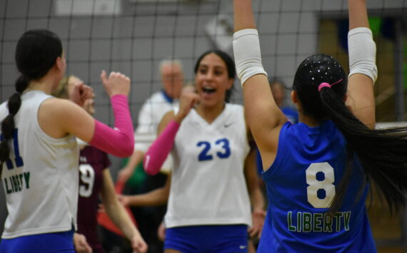 Charlize Espinosa throws her arms in the air after a Kendreah Beazer spike against Mercer Island. Ben Ray / The Reporter