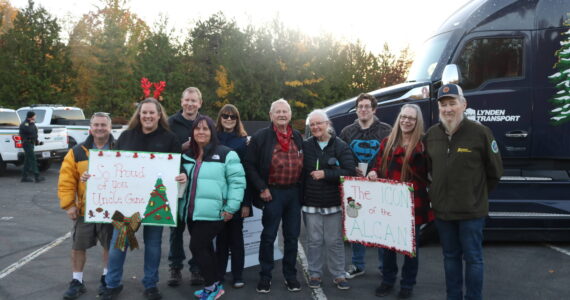 The Austin family arrived from all over Western Washington to greet Gene Austin, 89, (center) and John Schank (far right), the two drivers hauling the Christmas tree to Washington, D.C. Photo by Bailey Jo Josie/Sound Publishing.