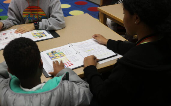 Before reading begins, coaches check-in with students on how their doing with little workbooks. Photo by Bailey Jo Josie/Sound Publishing.