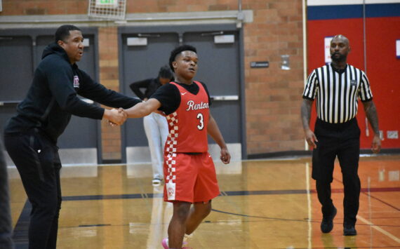 Isaac Elegan shakes hands with Head Coach Rashaad Powell in the win over Lindbergh. Ben Ray / The Reporter