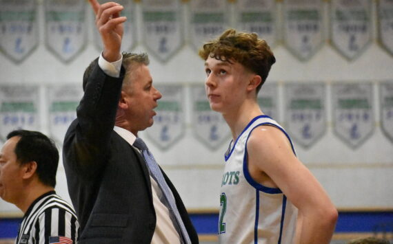 Liberty Head Coach Omar Parker talking with Jackson Whitaker during the fourth quarter. Ben Ray / The Reporter